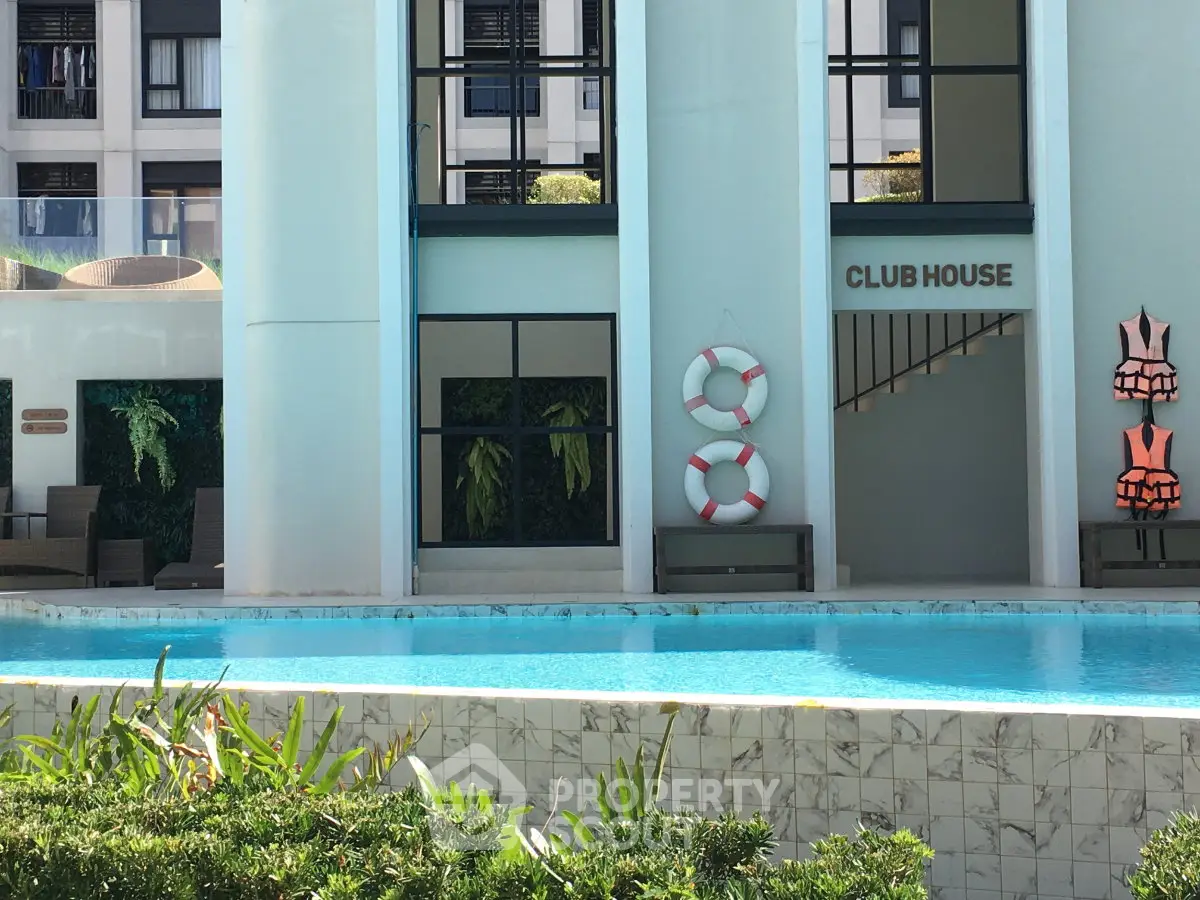 Luxurious clubhouse with poolside view and modern architecture, perfect for relaxation and leisure activities.