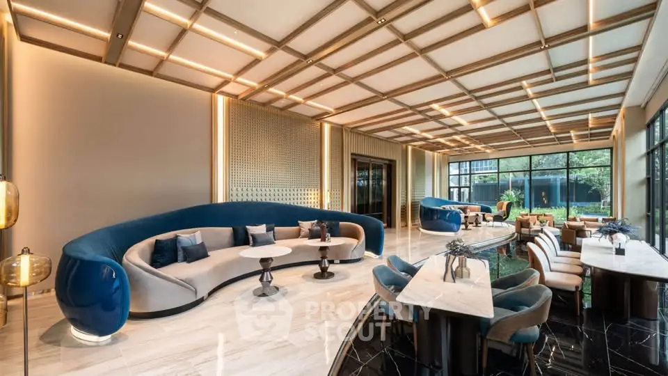 Luxurious modern living room with elegant furniture and large windows offering garden views.