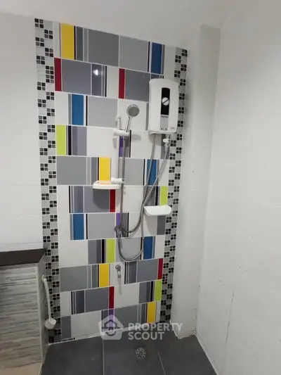 Modern bathroom with colorful tiled shower and water heater