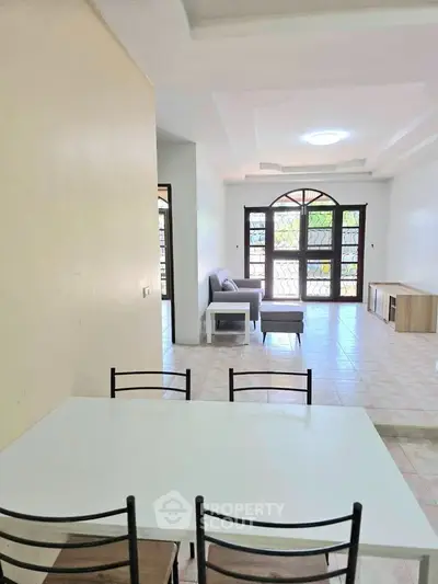 Spacious living room with modern furniture and large windows for natural light.