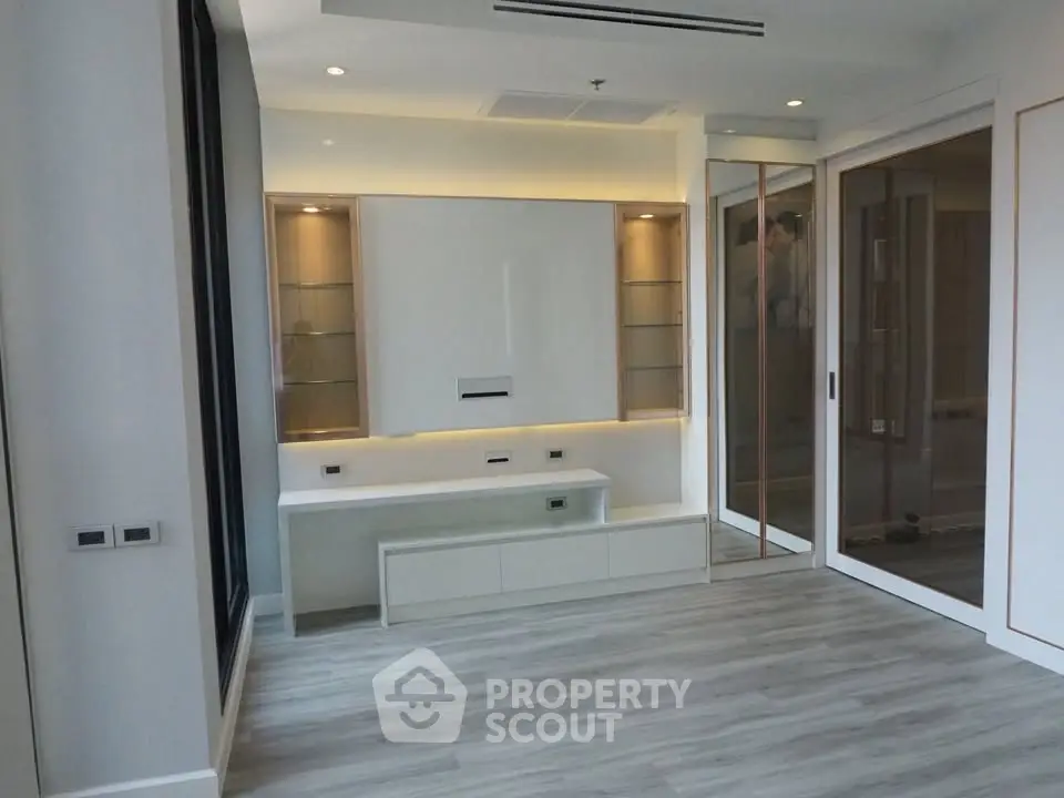 Modern living room with sleek built-in shelving and elegant lighting