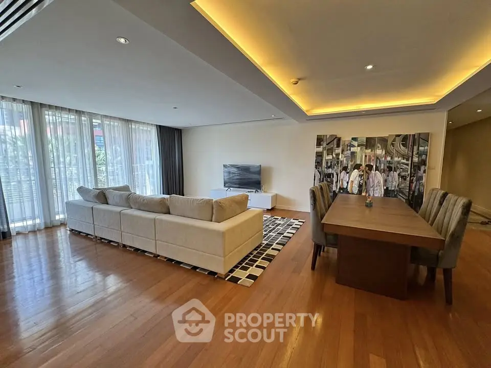 Spacious modern living room with elegant dining area and large windows.