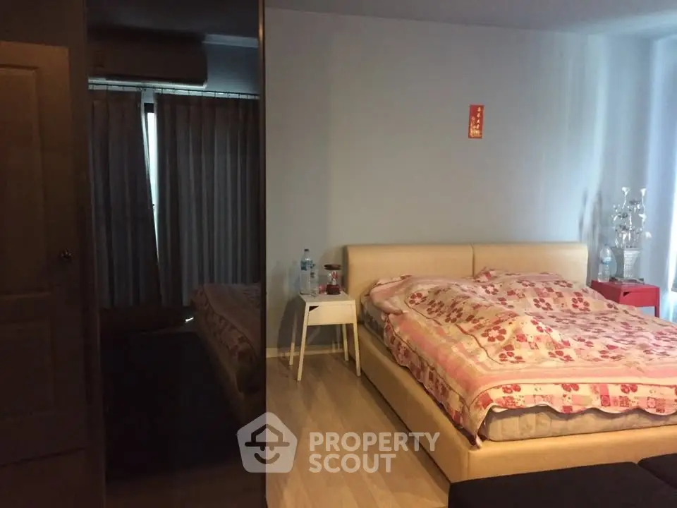 Cozy bedroom with floral bedding and modern decor in a stylish apartment.