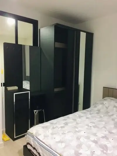 Modern bedroom with sleek black wardrobe and stylish decor