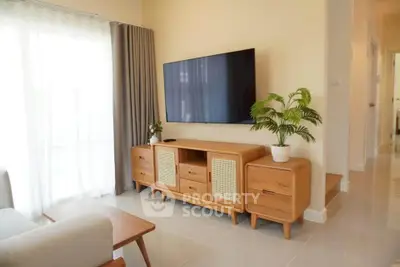 Modern living room with stylish wooden furniture and wall-mounted TV, bright and inviting space.