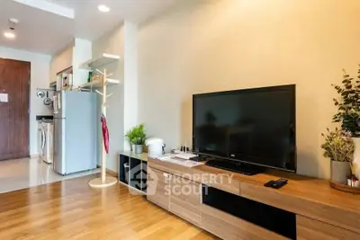 Modern living room with sleek TV unit and open kitchen layout