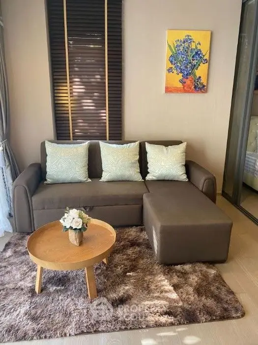 Cozy living room with modern sofa, stylish rug, and vibrant wall art.