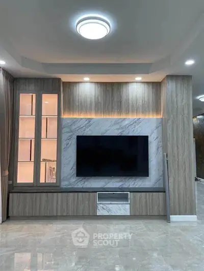 Modern living room with elegant TV wall unit and ambient lighting