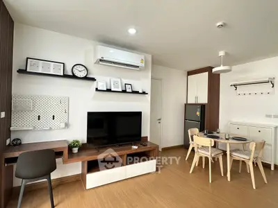 Modern living room with stylish furniture and dining area in open layout apartment.