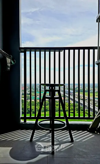 Chic balcony with stunning panoramic view and modern stool, perfect for relaxation and enjoying the scenery.