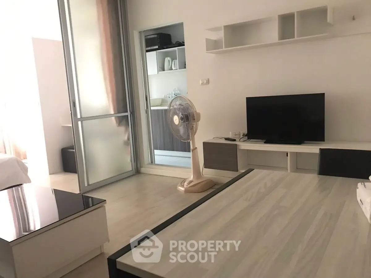 Modern living room with sleek furniture and open kitchen layout