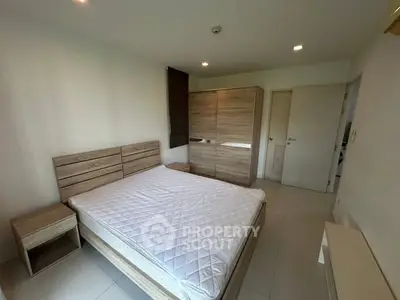 Spacious bedroom with modern wooden furniture and ample natural light