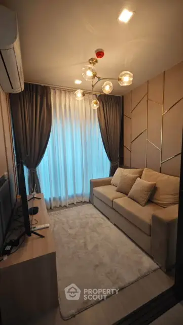 Cozy living room with modern decor, plush sofa, and elegant lighting in a stylish apartment.