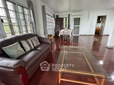 Spacious living room with elegant wooden flooring and large windows for natural light.