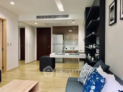 Modern open-layout living room with sleek kitchen and stylish decor