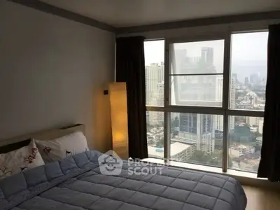 Cozy bedroom with city view and large windows in modern apartment