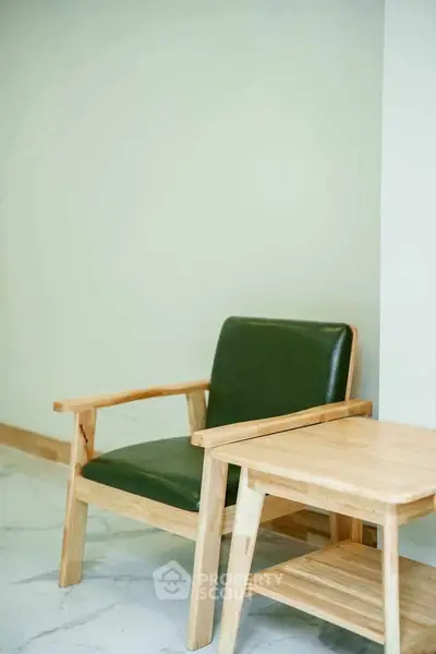 Minimalist wooden chair and table set on marble floor in modern interior.