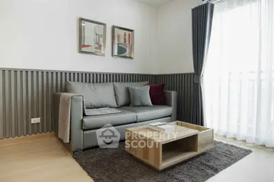 Modern living room with stylish sofa, wooden coffee table, and elegant decor in a bright, airy space.