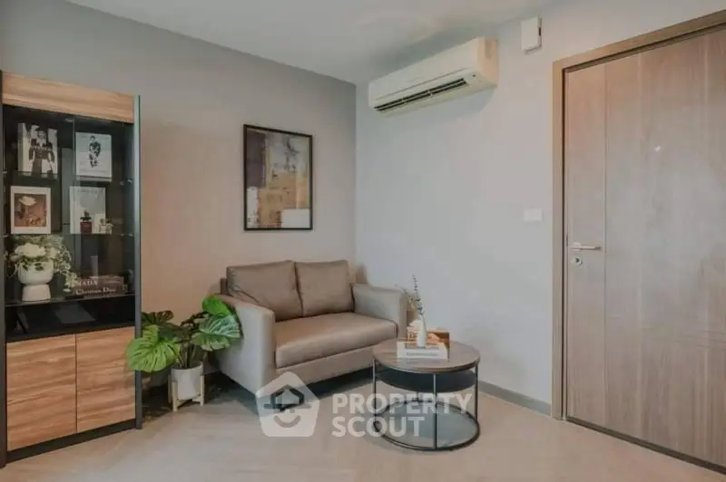 Cozy living room with modern decor and air conditioning, perfect for relaxation.