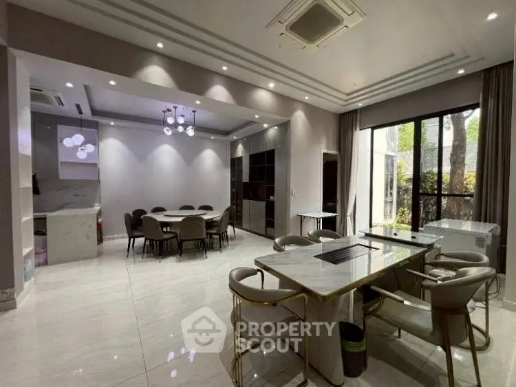 Spacious modern dining area with elegant lighting and large windows