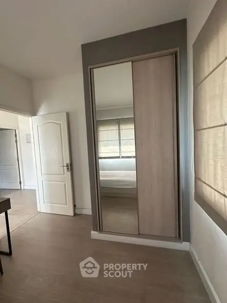 Modern bedroom with sliding wardrobe and neutral decor