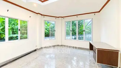 Spacious corner unit with large windows and lush garden views