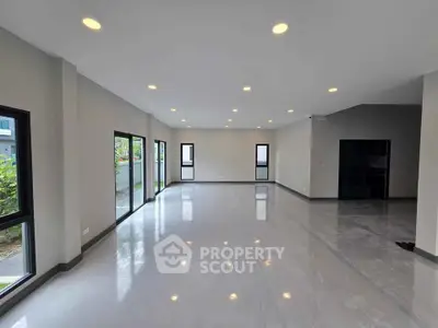 Spacious modern living room with large windows and sleek flooring