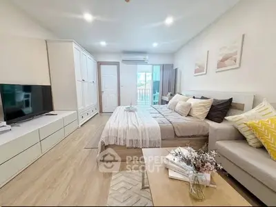 Spacious modern bedroom with cozy decor and natural light