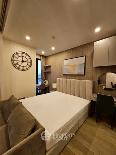 Luxurious bedroom with elegant decor and modern furnishings, featuring a plush bed and stylish wall art.