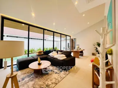 Spacious modern living room with large windows and stylish decor