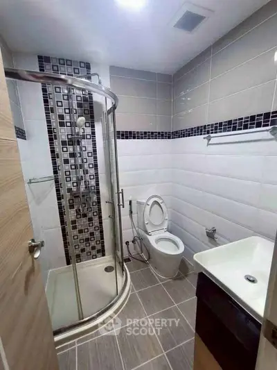 Modern bathroom with sleek shower enclosure and stylish tile design