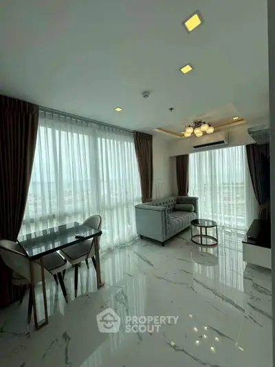 Modern living room with marble floors, large windows, and elegant furniture.