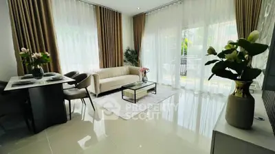Elegant living room with modern decor, large windows, and abundant natural light.