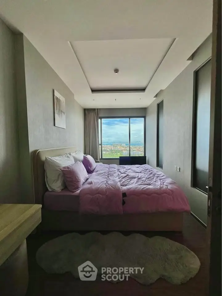 Luxurious bedroom with stunning city view and plush bedding