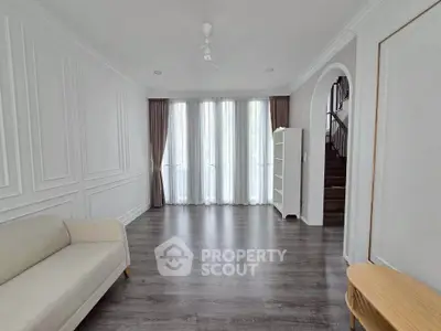 Spacious living room with elegant decor and large windows for natural light.