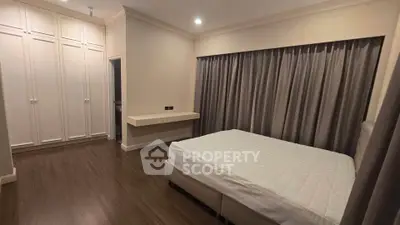 Spacious bedroom with elegant design and ample storage in modern real estate property.