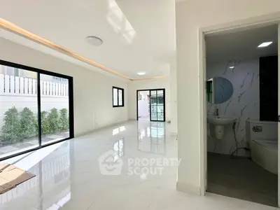 Spacious modern living room with large windows and marble flooring