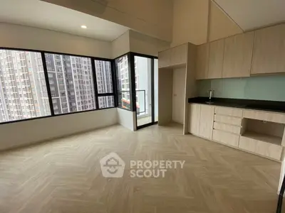 Spacious modern living room with large windows and open kitchen layout