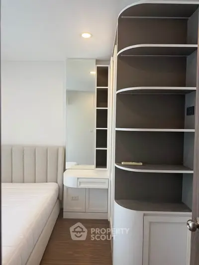 Modern bedroom with sleek built-in storage and cozy bed