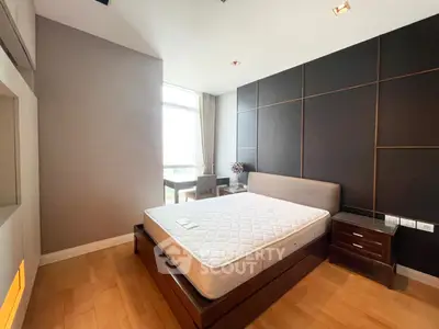 Modern bedroom with large window and stylish decor in a luxury apartment