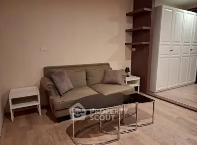 Cozy living room with modern sofa and stylish coffee table in a chic apartment.