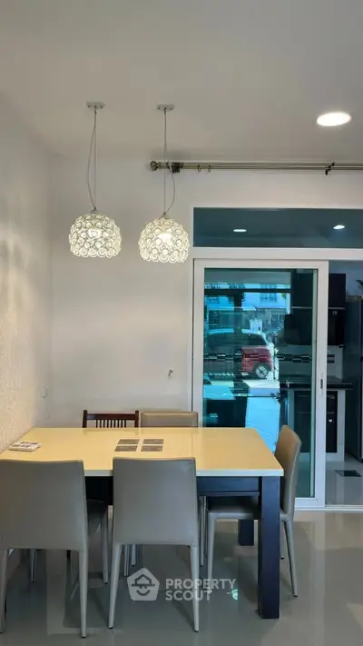 Modern dining area with stylish lighting and sliding glass doors