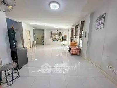 Spacious living room with modern decor and large windows