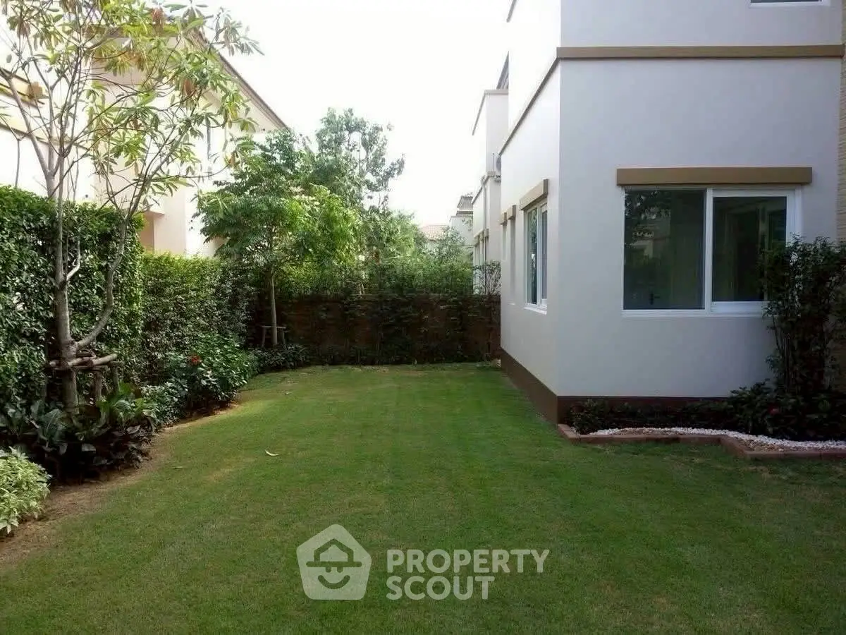 Charming garden view of a modern home with lush greenery and manicured lawn.