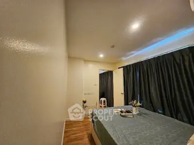 Cozy bedroom with modern decor and soft lighting, perfect for relaxation.