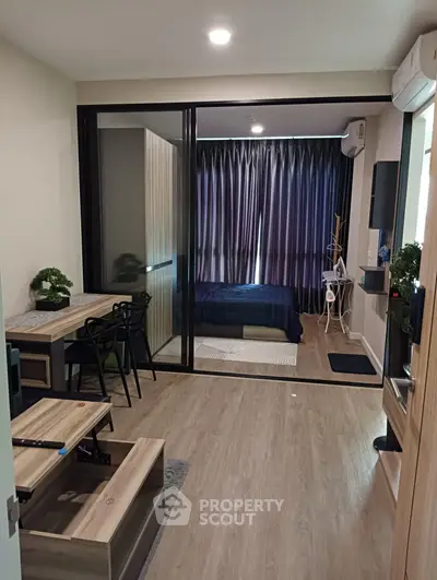 Modern apartment interior with open living and bedroom space, featuring sleek furniture and stylish decor.