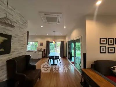 Spacious open-plan living room with modern decor and garden view