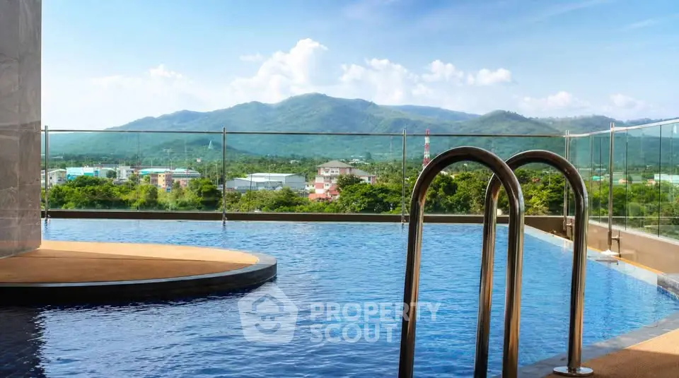 Luxurious rooftop pool with stunning mountain views and clear blue skies.