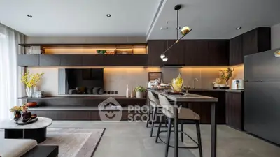 Modern kitchen with sleek cabinetry and stylish island in open layout apartment.
