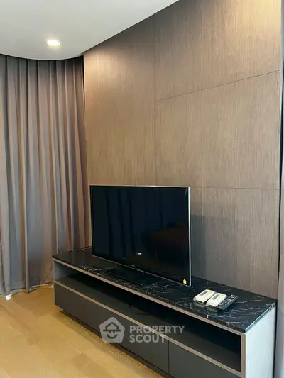 Modern living room with sleek TV setup and elegant wood paneling